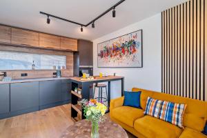 a living room with a yellow couch and a kitchen at 1 Bed in St. Andrews oc-c30132 in St. Andrews