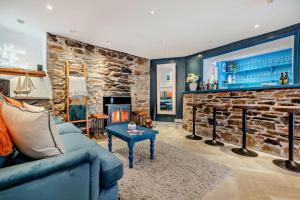 a living room with a blue couch and a stone fireplace at 7 Bed in St. Agnes oc-p28968 in St. Agnes