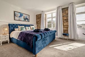 a bedroom with a blue bed and a window at 7 Bed in St. Agnes oc-p28968 in St. Agnes