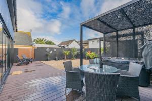 a patio with a table and chairs on a deck at 2 Bed in Lancing oc-t29902 in Lancing