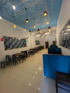 a waiting room with tables and chairs in a building at Royal living hotal in Bathinda