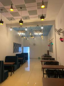 a dining room with tables and chairs and lights at Royal living hotal in Bathinda
