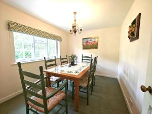 a dining room with a wooden table and chairs at 2 Bed in Chilmark oc-w32753 in Chilmark
