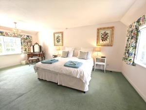 a bedroom with a white bed and two windows at 2 Bed in Chilmark oc-w32753 in Chilmark +4 photos