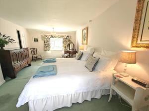 a bedroom with a large white bed and a desk at 2 Bed in Chilmark oc-w32753 in Chilmark