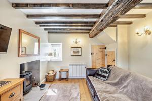a living room with a couch and a fireplace at 1 Bed in Warslow oc-h27591 in Warslow