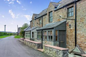 an old stone building with windows and a driveway at 2 Bed in Belford oc-c29288 in Fenham