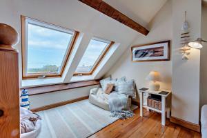 a living room with a couch and two windows at 2 Bed in Belford oc-c29288 in Fenham