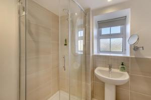 a white bathroom with a sink and a shower at 2 Bed in Langthwaite oc-c30568 in Low Eskcleth +16 photos