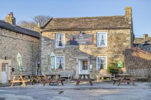 a group of picnic tables outside of a building at 2 Bed in Langthwaite oc-c30568 in Low Eskcleth