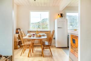a kitchen with a table and a refrigerator at 2 Bed in Lochinver oc-t30029 in Clachtoll