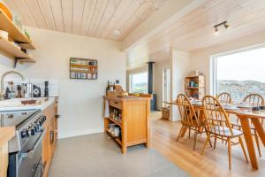 a kitchen with a table and chairs and a dining room at 2 Bed in Lochinver oc-t30029 in Clachtoll +24 photos