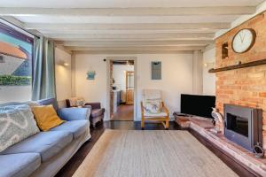 a living room with a couch and a fireplace at 2 Bed in Sheringham oc-2310 in Sheringham
