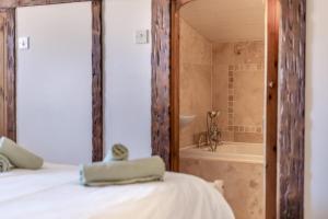 a bedroom with a bed and a tub and a shower at 2 Bed in Sheringham oc-2310 in Sheringham +20 photos