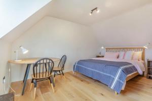 a bedroom with a bed and a table and chairs at 2 Bed in Lochinver oc-t30029 in Clachtoll