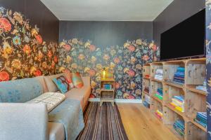 a living room with a couch and a wall mural at 2 Bed in Lochinver oc-t30029 in Clachtoll
