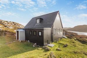 a house on the side of a hill at 2 Bed in Lochinver oc-t30029 in Clachtoll