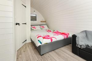 a bedroom with a bed with pink flamingos on it at 1 Bed in Abersoch oc-thepod in Abersoch