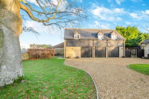 a large house with a garage and a driveway at 1 Bed in Woodstock oc-u30547 in Kidlington