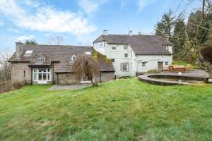 a large white house with a large yard at 6 Bed in Llanfilo oc-e30630 in Llandefalle
