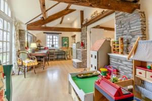 a kitchen and dining room with a stone wall at 6 Bed in Llanfilo oc-e30630 in Llandefalle