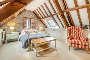 a bedroom with a bed and a chair and a table at 6 Bed in Llanfilo oc-e30630 in Llandefalle