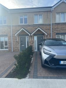 a car parked in front of a brick house at Precious Home in Monasterevin