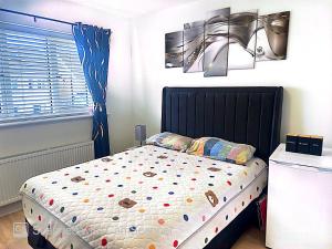 a bedroom with a bed with polka dot sheets at Precious Home in Monasterevin