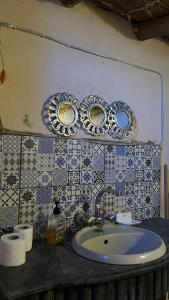 a bathroom with a sink and blue and white tiles at Siwa Bait Ward Home in Siwa +79 photos
