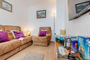 a living room with a couch and two chairs and boxes at 3 Bed in Ilfracombe oc-s29585 in Ilfracombe