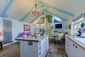a kitchen with white cabinets and a dining room at 1 Bed in St. Ives oc-e28023 in St Ives