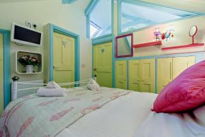 a bedroom with a large bed and yellow cabinets at 1 Bed in St. Ives oc-e28023 in St Ives