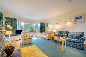 a living room with couches chairs and a table at 3 Bed in North Connel oc-a29963 in Connel