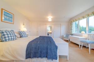 a bedroom with a bed and a desk and window at 3 Bed in North Connel oc-a29963 in Connel