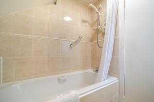 a bathroom with a white tub and a shower at 3 Bed in North Connel oc-a29963 in Connel +20 photos