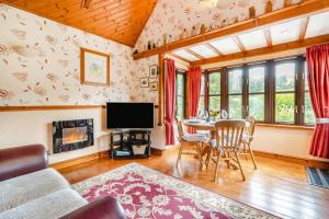 a living room with a table and a tv at 2 Bed in Devils Bridge oc-d29575 in Devils Bridge