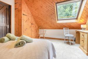 a bedroom with a bed and two chairs and a window at 2 Bed in Devils Bridge oc-d29575 in Devils Bridge