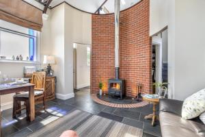 a living room with a fireplace and a brick wall at 1 Bed in Toynton All Saints oc-s29840 in Toynton All Saints