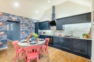 a kitchen with a table with pink chairs and a sink at 2 Bed in Wycliffe oc-r29947 in Wycliffe