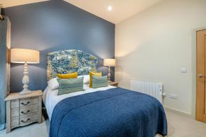 a blue bedroom with a bed and two lamps at 2 Bed in Wycliffe oc-r29947 in Wycliffe