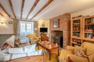 a living room with a couch and a brick fireplace at 2 Bed in Corfe Castle oc-a30970 in Corfe Castle