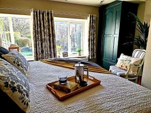 a bedroom with a bed with a tray on it at 4 Bed in Little Hayfield oc-c31097 in Hayfield