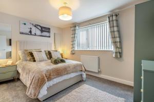 a bedroom with a large bed and a window at 3 Bed in Rhyl oc-p30593 in Rhyl