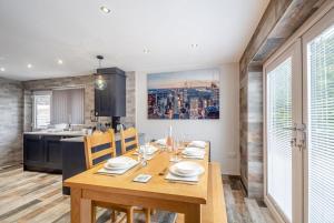 a dining room with a wooden table and a kitchen at 3 Bed in Rhyl oc-p30593 in Rhyl +19 photos