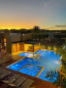 a large swimming pool with chairs in a backyard at Pousada Villas Bonito in Bonito