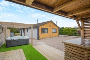 a backyard with a hot tub and a house at 3 Bed in Rhyl oc-p30593 in Rhyl