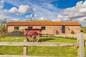 a red wagon in front of a brick building at 1 Bed in Saltfleetby oc-b30073 in Saltfleetby Saint Peter