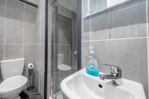 a bathroom with a white sink and a toilet at 1 Bed in Tenby oc-w28984 in Tenby +13 photos