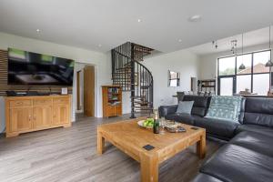 a living room with a couch and a coffee table at 4 Bed in Saham Toney oc-o30348 in Saham Toney