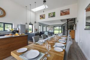 a dining room and kitchen with a long table and chairs at 4 Bed in Saham Toney oc-o30348 in Saham Toney